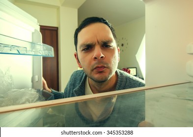 Hungry Man With Funny Face Opens The Fridge