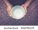 A hungry man holding an empty bowl