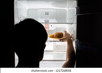 Hungry Man Taking Burger From The Empty Fridge At Night