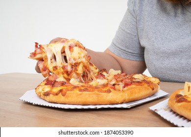 Hungry Overweight Woman Holding Pizza And Happy To Eat Pizza. Concept Of Binge Eating Disorder (BED) And Relaxing With Eating Junk Food And Unhealthy Foods.