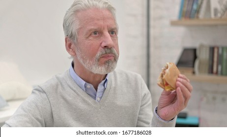 Hungry Senior Old Man Eating Cheese Burger