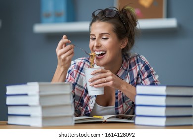 Hungry Student Eating Noodle While Learning At Home