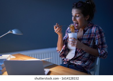 Hungry Student Eating Noodle While Learning At Home