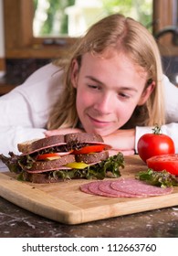 Hungry Teen Boy After School Making A Sandwich