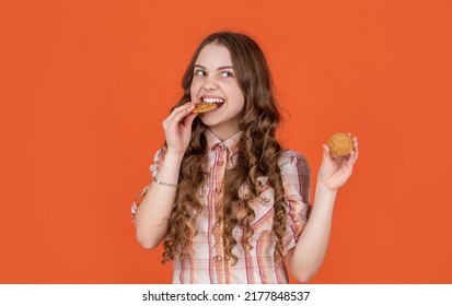 Hungry Teen Girl With Oatmeal Cookies On Orange Background