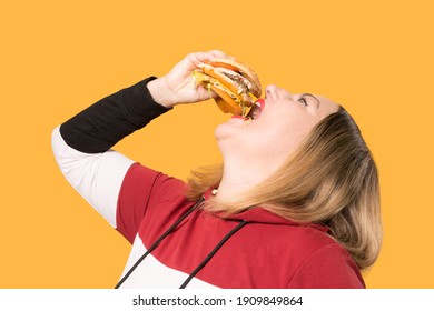 A Hungry Woman Is Biting A Big Tasty Burger.