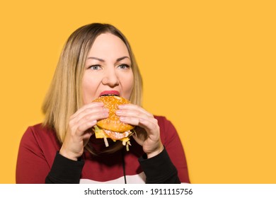 A Hungry Woman Is Biting A Big Tasty Burger.