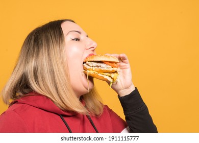 A Hungry Woman Is Biting A Big Tasty Burger.