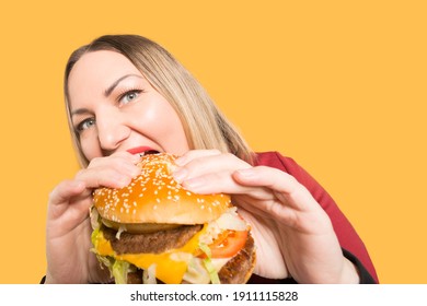 A Hungry Woman Is Biting A Big Tasty Burger. . Unhealthy Food