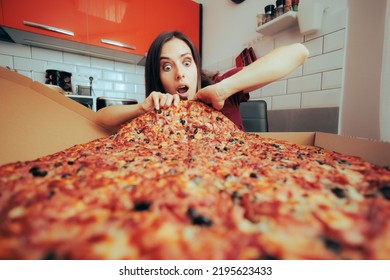 
Hungry Woman Eating A Large Pizza By Herself In The Kitchen. Girl Craving For A Huge Portion Of Italian Delicious Dish 
