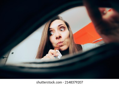 
Hungry Woman Snacking On The Chocolate Found In Her Purse. Girl With A Sweet Tooth Craving Dessert Meal During Lunch Break
