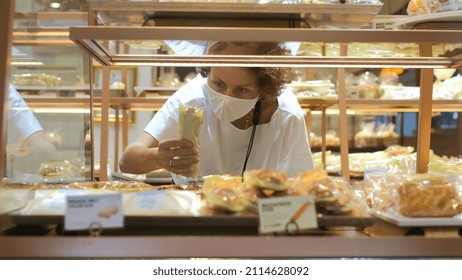 Hungry Young Lady Choosing And Taking From Display Meal For Lunch In Buffet Cafeteria, Customer In Cookery