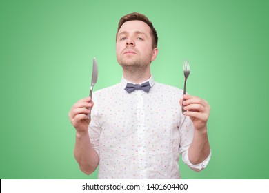 Hungry Young Man Holding Fork And Knife On Hand Ready To Eat. Diet And Healthy Foo Concept.