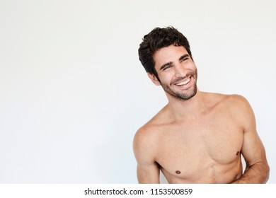 Hunky topless guy smiling in studio - Powered by Shutterstock