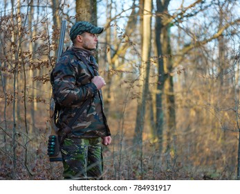 Hunter In Camo Suit With Double Barrel Shotgun