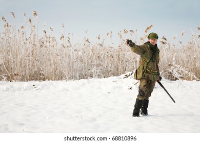 Hunter Giving Directions To The Other Hunters. General Winter Hunting Scene During The Open Season