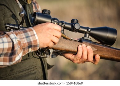 Hunter Holding A Rifle