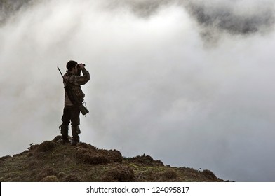 hunter looking for game animals such as chamois, deer or tahr, in  South Westland's Southern Alps, New Zealand - Powered by Shutterstock