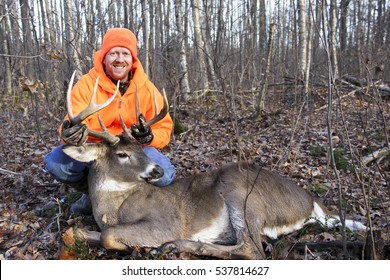 Hunter With A Monster Trophy Whitetail Buck In The Woods