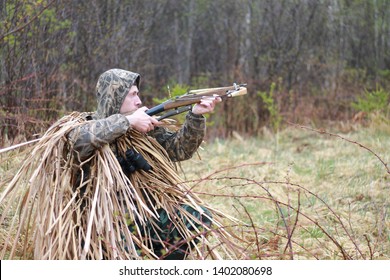 Hunter shooting with a crossbow in spring forest - Powered by Shutterstock