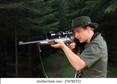 A Hunter Shooting With His Rifle