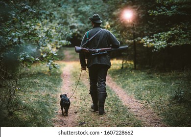 hunter in the woods with his dog