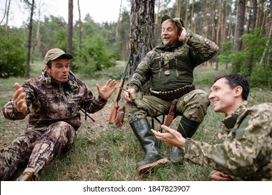 Hunters sit in the forest and talk about a great hunt. Hunters share hunting experiences and tells funny stories. 