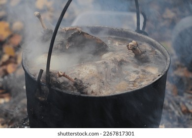 Hunting broth. Wild fowl (waterfowl, goose). Rich soup on stake is cooked hunting chowder in boiler (Game stew). Northern original recipe. Food that is thousands of years old, prehistoric civilization - Shutterstock ID 2267817301