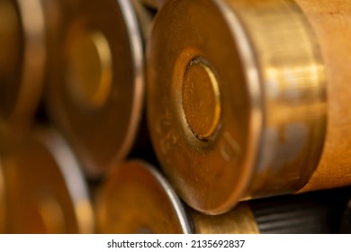 Hunting Cartridges On A Textured Background, Close-up, Selective Focus. Concept: Bird Hunting, Hunting Ammunition, Large And Small Caliber.