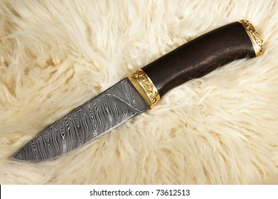 The hunting knife on a skin of a ram