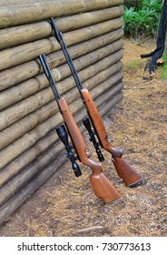 Hunting Rifles By A Log Wall In The UK
