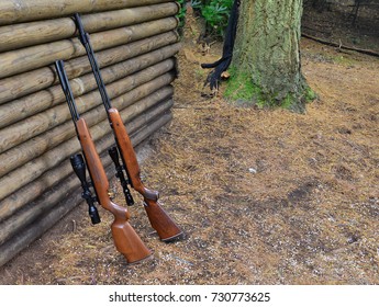 Hunting Rifles By A Log Wall In The UK
