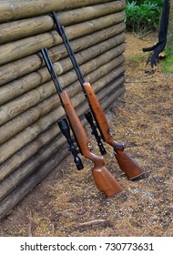 Hunting Rifles By A Log Wall In The UK
