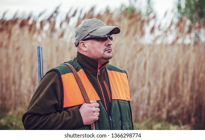 Hunting season. Hunter with a rifle in the field - Shutterstock ID 1366298774