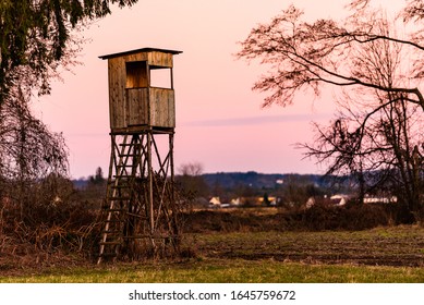 Hunting Tower After Sunset In Rural Scenery Against Pink Sky. Deer Stand Near Zettling Graz In Austria. Hunting Concept