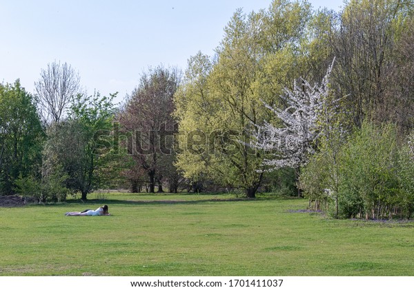 Huntingdon, Cambridgeshire, UK. April 11th\
2020. Hinchingbrooke country park very empty on a very sunny easter\
Saturday during Covid-19 UK lockdown. People out for their once per\
day exercise.