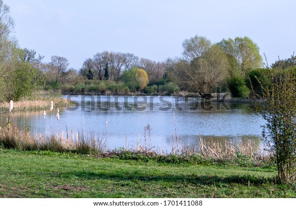 Huntingdon, Cambridgeshire, UK. April 11th\
2020. Hinchingbrooke country park very empty on a very sunny easter\
Saturday during Covid-19 UK lockdown. People out for their once per\
day exercise.