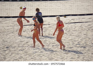 HUNTINGTON BEACH, CA - APRIL 16, 2021: Female beach volleyball players competing on Huntington Beach sand                        