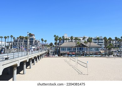 HUNTINGTON BEACH, CALIFORNIA, 19 SEPT 2022: HB Pier Looking Towards Main Street With Dukes Restaurant And Volleyball Courts.