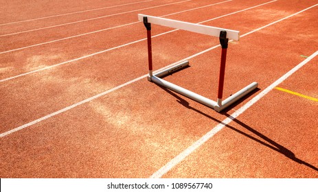 hurdle race barrier obstacle on red  running track , athletic stadium - Shutterstock ID 1089567740