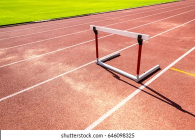 hurdle race barrier on red  running track , athletic stadium - Powered by Shutterstock