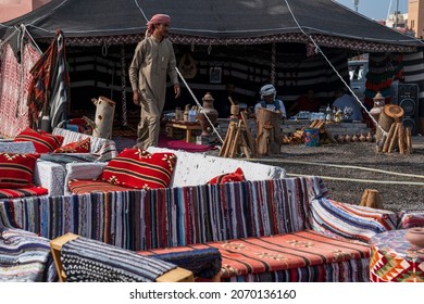 Hurghada, Egypt, November 03, 2021: An Arabic-style Cafe With Low Armchairs, Sofas And Tables For Drinks, Guests Drinking Tea And Coffee In The Shade Inside The Tent, An African Man Brewing Coffee