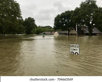 Hurricane Harvey 2017, flooding in Spring Texas, a couple miles north of Houston. Speed limit sign almost completely submerged. - Shutterstock ID 704663569