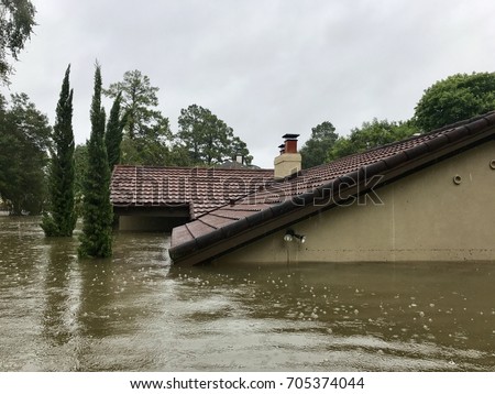 Hurricane Harvey 2017, flooding in Spring Texas a couple miles north of Houston off East Cypresswood  Drive. This house is almost completely submerged from the rain and rising bayou.
