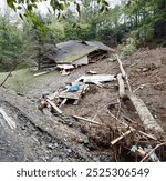 Hurricane Helene intensifies, causing vehicles and houses to crash under powerful waves and storm surge, leaving widespread destruction in its path.