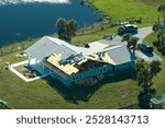 Hurricane Ian destroyed house roof in Florida residential area. Natural disaster and its consequences