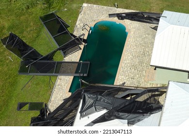 Hurricane Ian Destroyed Swimming Pool Lanai Enclosure On House Yard In Florida Residential Area. Natural Disaster And Its Consequences