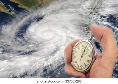 Hurricane Patricia and Hand Holding old Stopwatch. Concept of Climate change. Elements of this image furnished by NASA - Powered by Shutterstock