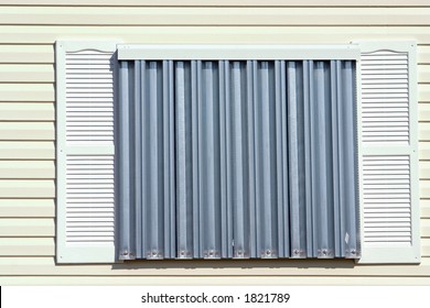 Hurricane protection corrugated metal panels installed on tropical home