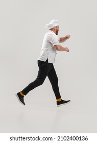 Hurry Up. Portrait Of Cook, Chef Man Wearing Restraunt Uniform Running To Kitchen Isolated On White Background. Cuisine, Profession, Occupation, Funny Meme Emotions Concept. Copyspace For Ad.